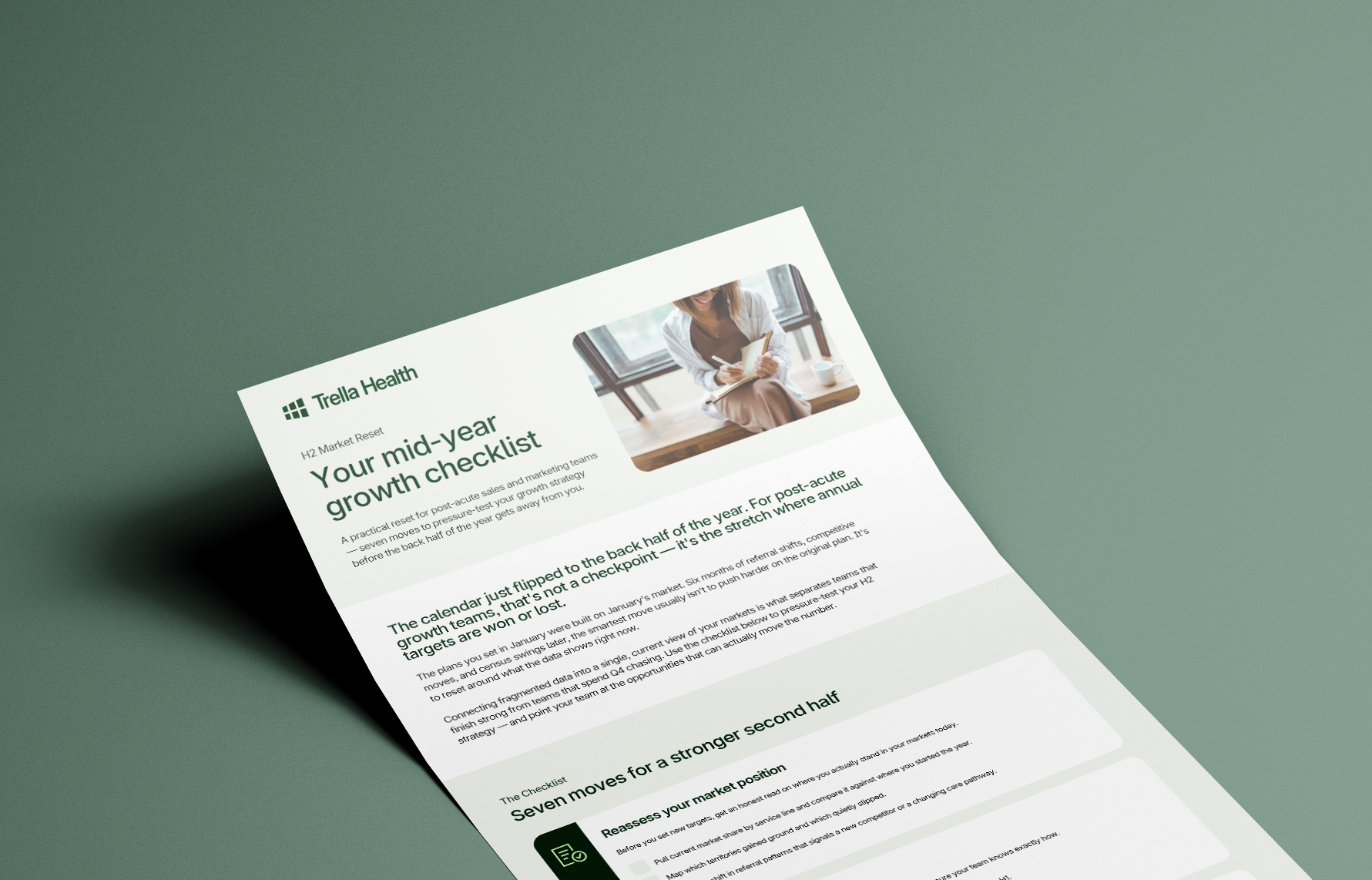 A printed Telia Health flyer titled “Your mid-year growth checklist” lies on a green surface; it features a header image of a woman writing in a notebook.